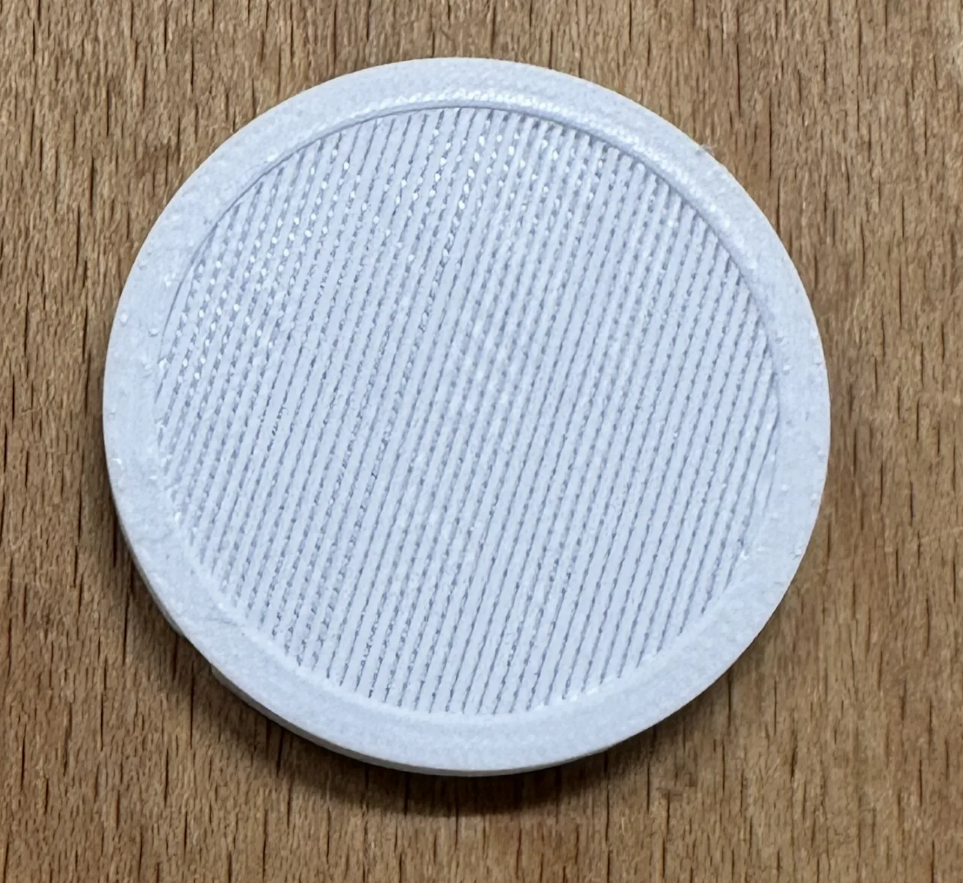 Close-up photograph of the printed filter support, individual in-air printed strands visible.