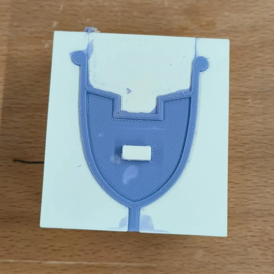 One half of the Duckbill cup, cast in purple silicone, still sitting in its open printed mould half.