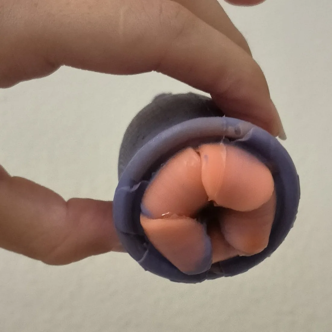 The Flower High prototype cast in silicone: a purple cup with orange petals sitting close to the rim.