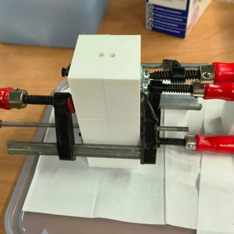 A printed mould, held shut with bar clamps, ready for casting.