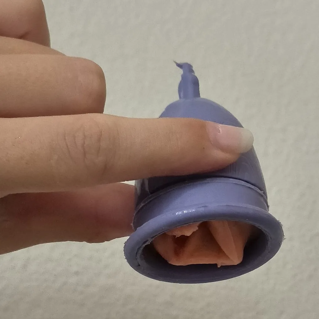 The Twister prototype cast in silicone: an orange inner skin visible inside the purple cup.