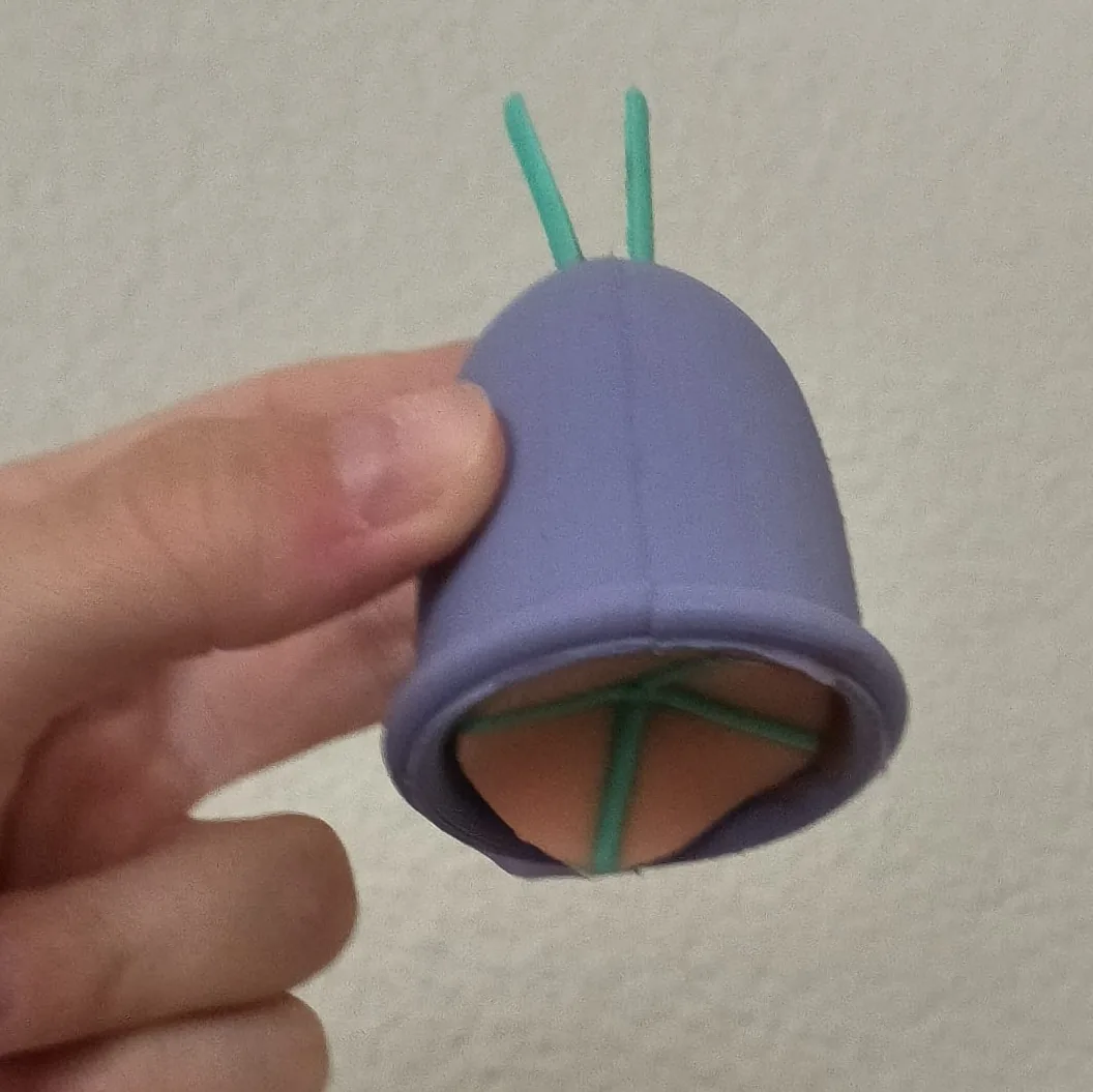 The Umbrella prototype cast in silicone: an orange umbrella structure on a green frame inside the opening.