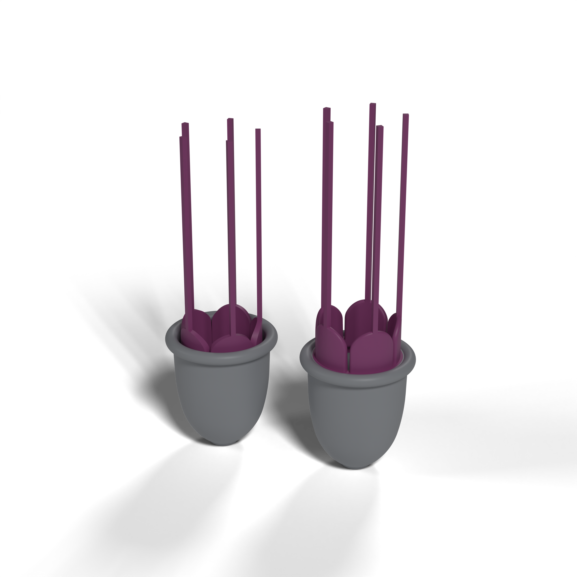 Flower Low and Flower High side by side: grey silicone cups with their petals and strings in purple; in Flower High the petal bases sit nearer the rim. The strings are shown straight, as cast.